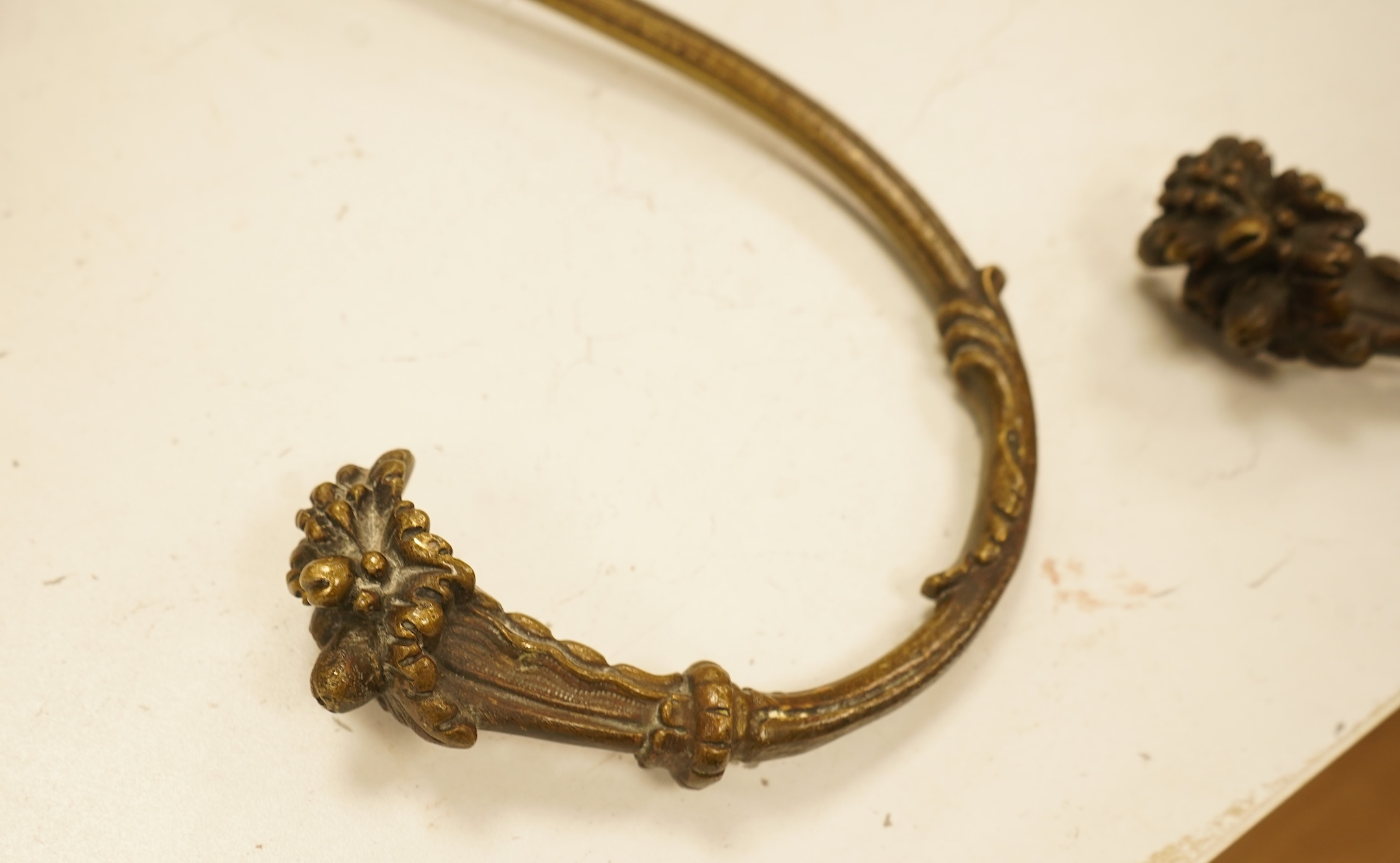 A set of four cast brass curtain tie backs, early 20th century